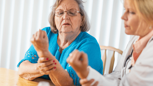 A woman exercising her forearm with an occupational therapist for carpal tunnel