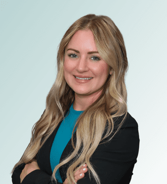 woman smiling, wearing a suit