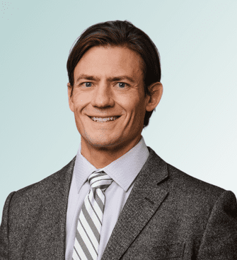 Bret Peterson man smiling, wearing a suit and tie
