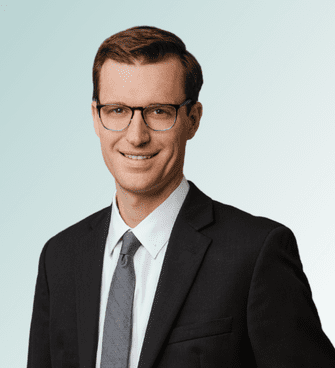 Chris Stockburger Johnson man smiling, wearing a suit