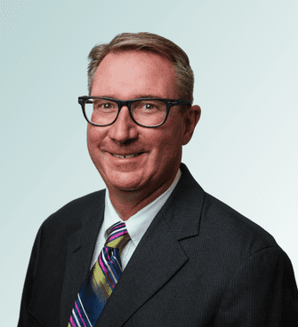 Gregg Koldenhoven Johnson man smiling, wearing a suit