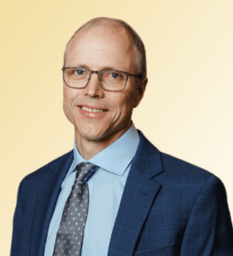 Matt Crawford man smiling, wearing glasses and a suit and tie