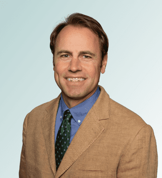 Rick Morgan man smiling, wearing a suit