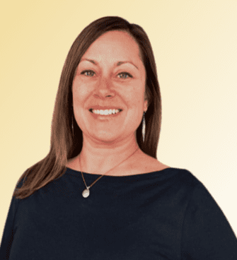 Sheri Deuto woman smiling, wearing a necklace and a black shirt