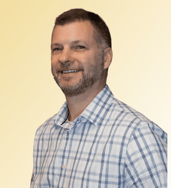 Dave man smiling, wearing plaid shirt