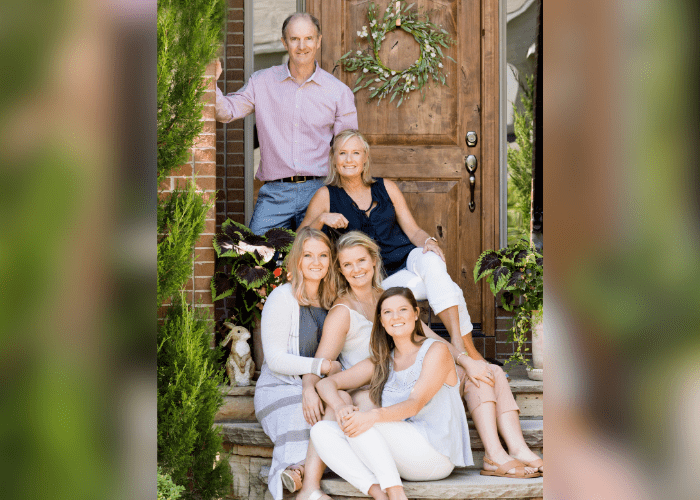Fitzgibbons 1 A family of 5 sitting on the steps in front of a door