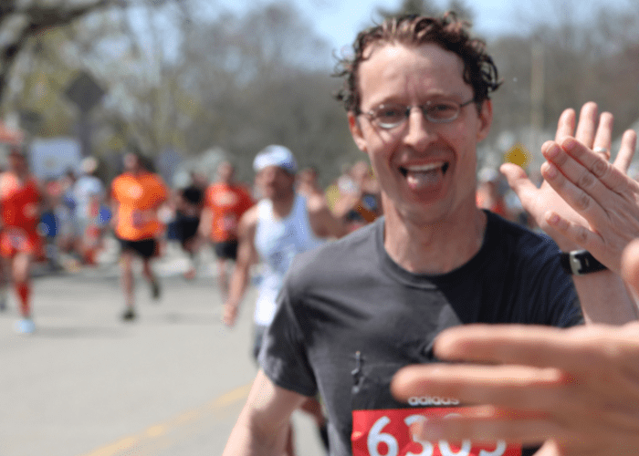 Hunt 3 a man high fiving someone as he finishes a race
