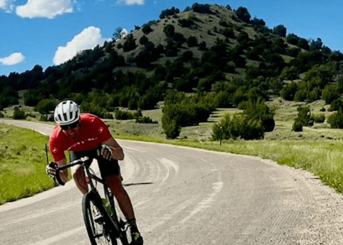 morgan 1 man on a bike with a green mountain behind him