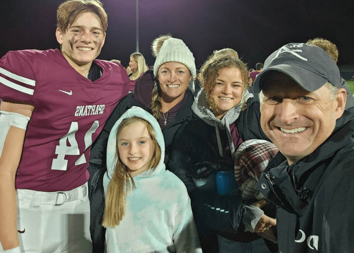 a family of 5 taking a selfie on a football field a family of 5 taking a selfie on a football field