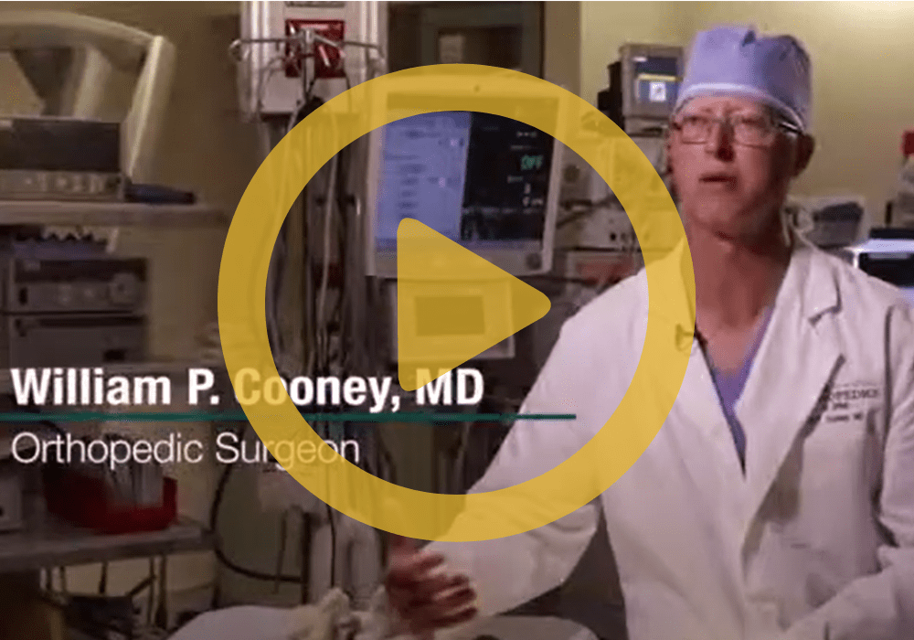 Cooney Dr. Cooney in an operating room with a play sign