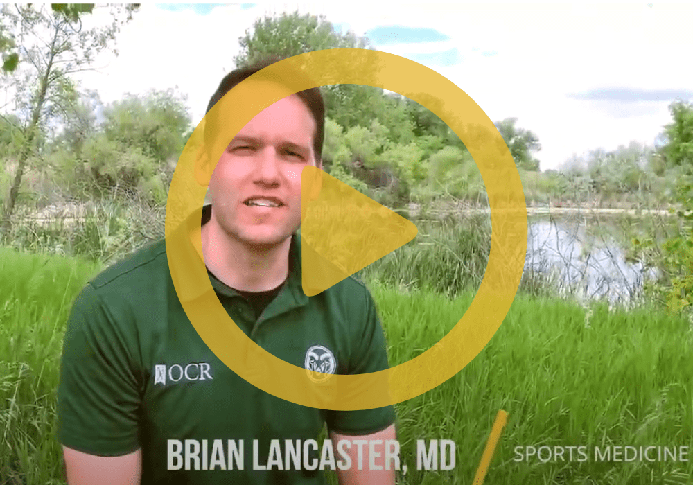 Lancaster A man in a green shirt sitting in front of a lake with a play button on top