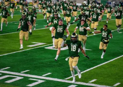 CSU football team running on the field