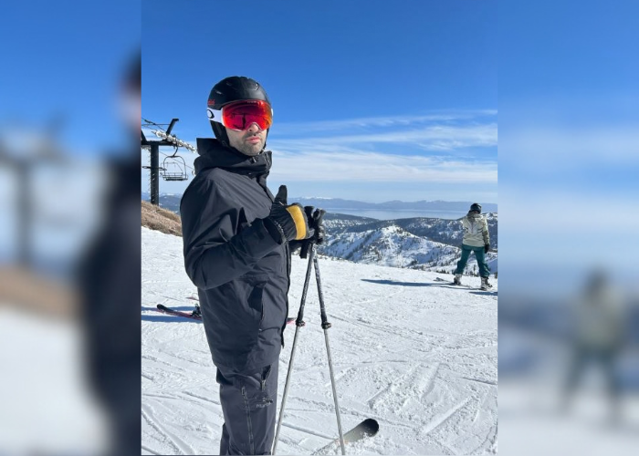 Dr. Robert Matar standing in a skiing outfit and skiing on a mountain