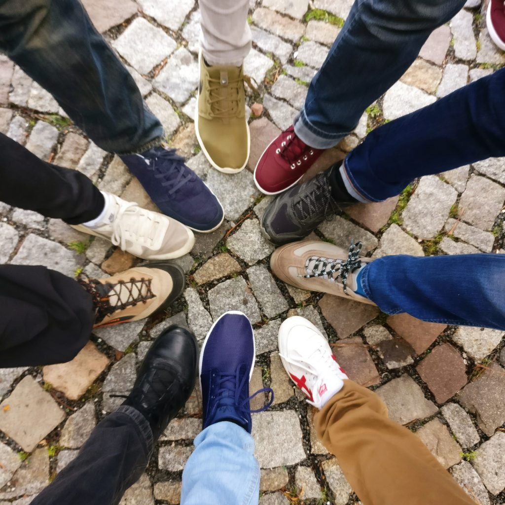 People in a circle showing their different shoes