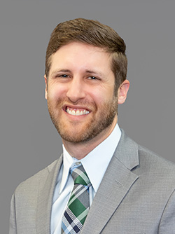 man smiling wearing a suit